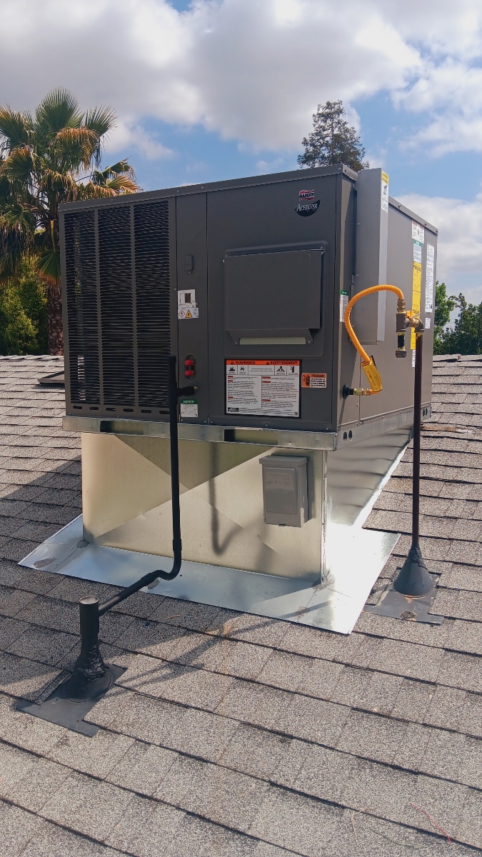 Ruud rooftop package HVAC system installed on a residential roof